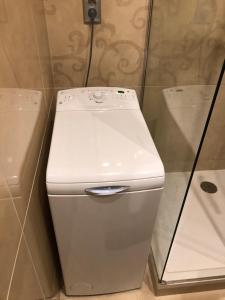 a white toilet in a bathroom next to a shower at Šafran Apartment LUX in Donovaly +55 photos