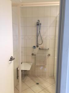 a bathroom with a shower with a toilet at Red Bridge Motor Inn in Woombye