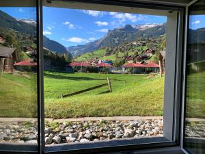 a view from a window of a village at Brand New, 5min to Ski PARADISE ! in Grindelwald +26 photos