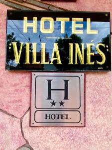 a sign on a wall with a hotel sign at Hotel Villa Inés Mendoza in Mendoza