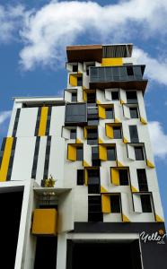 a tall building with yellow windows on it at Yello Hotel Cebu powered by Cocotel in Cebu City