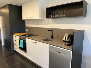 Midnight Luxe 1BR 1Bath Apartment 104 in the heart of Braddon Pool Sauna Secure Parking Wine WiFi的厨房或小厨房