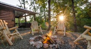 two chairs sitting around a fire in a yard at Sunsettin Cabin Free Parking Onsite in Stephens Gap