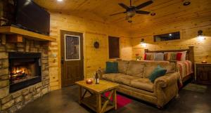 a living room with a couch and a fireplace at Sunsettin Cabin Free Parking Onsite in Stephens Gap