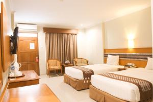 Postelja oz. postelje v sobi nastanitve Cakra Kembang Hotel