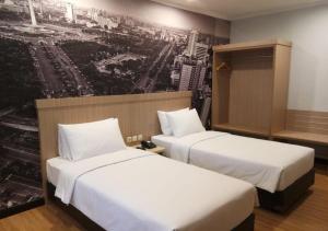 Postel nebo postele na pokoji v ubytování GiiA Sanno Hotel Pluit