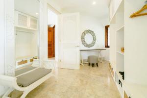 a white room with a bed and a table at Avillion Villa Cinta @Sanur, Bali in Sanur +28 photos