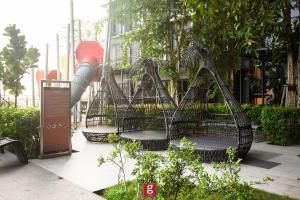 a group of benches in a garden with trees at EXPRESSIONZ KLCC BY G Suites in Kuala Lumpur