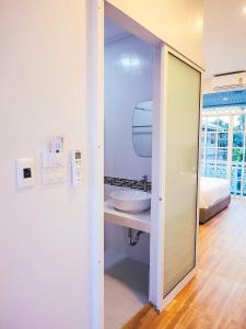 a bathroom with a sink and a mirror at Promporn Boutique Hotel in Nan