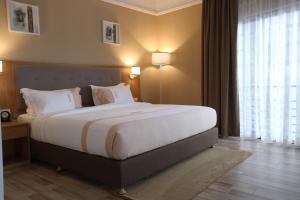 Postel nebo postele na pokoji v ubytování Mado Hotel