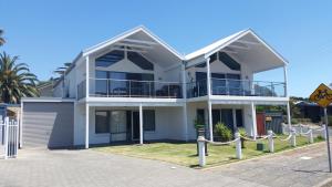a white house with a balcony on a street at Port Elliot Beachcomber on Horseshoe Bay linen included spotless in Port Elliot