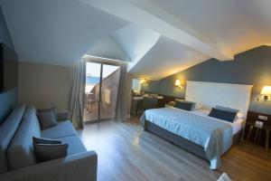 a hotel room with a bed and a couch at Fame Residence Kemer & Spa in Kemer