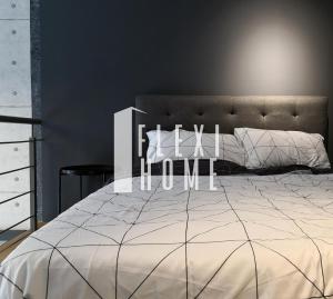 a bedroom with a large bed with a white bedspread at NETFLIX-Pinnacle PJ, Fantastic City View, 1-6 Guests Designed Duplex Home by Flexihome-MY in Petaling Jaya