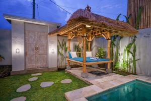 a room with a gazebo next to a pool at Luxury Villa Summerlin in Canggu