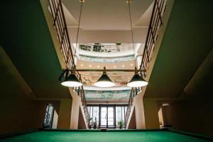 a pool table in a building with two lights at AZIMUT Hotel Uglich in Uglich
