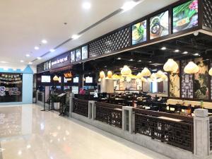 a fast food restaurant with a bar with lights at Luxury Condotel 2BR Vinhomes Skylake Keangnam - Netflix free in Hanoi