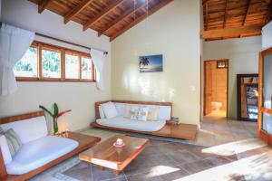 a living room with two couches and a table at Villas Santa Teresa in Santa Teresa Beach