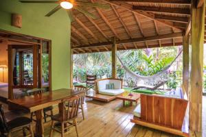 a living room with a wooden table and chairs at Villas Santa Teresa in Santa Teresa Beach