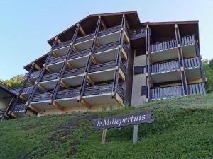 a building on a hill with a sign in front of it at Studio le Grand-Bornand Village in Le Grand-Bornand
