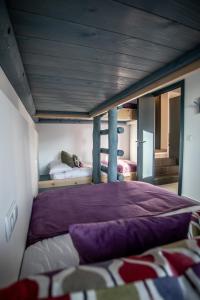 a bedroom with a large bed with a purple blanket at Cielo in Sierra Nevada