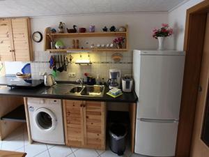 a small kitchen with a sink and a refrigerator at Ferienwohnung Noack in Kranichfeld