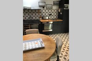 a kitchen with a wooden table with a bowl on it at LA MARLIERE maison de charme à la campagne in Houthem