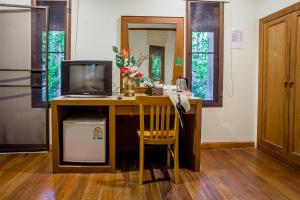 a living room with a tv and a desk at Aonang Cliff View Resort SHA Extra Plus in Ao Nang Beach