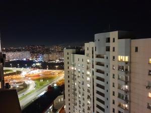 a view of a city at night with buildings at Шикарные апартаменты 3 минуты пешком от м Позняки in Kyiv