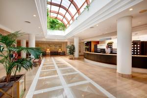 a lobby of a hotel with a skylight at Welikehotel Marfil Playa in Sa Coma