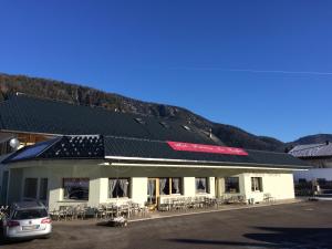 a building with a car parked in front of it at Da Alsido in Camporosso in Valcanale