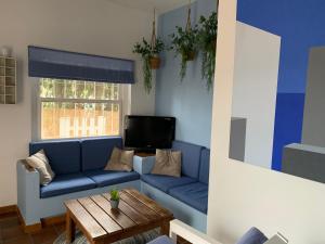 a living room with a blue couch and a table at "NeW" Casita Azul in Denia