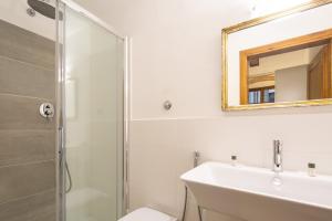 a bathroom with a shower and a sink and a mirror at Lambertesca Loft in Florence
