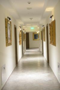 a hallway in a building with paintings on the walls at Srpsko Andrejevo Selo in Belgrade
