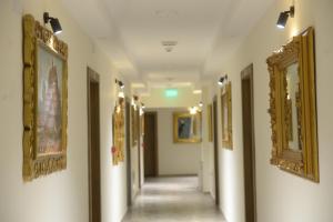 a corridor of a hallway with paintings on the walls at Srpsko Andrejevo Selo in Belgrade