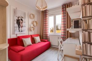 a living room with a red couch and a window at Apartament Agnes blisko Term Cieplice in Jelenia Góra