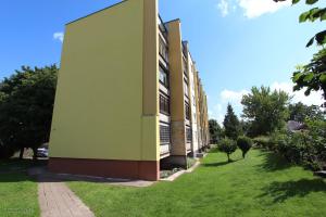 a building with a green wall on the side of it at Lukšio Apartment in Šiauliai