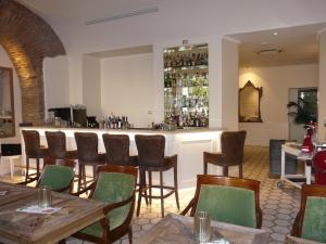 a bar in a restaurant with wooden tables and chairs at Hotel Milton Roma in Rome