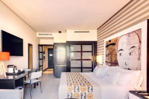 a hotel room with a bed and a desk at Royal Hideaway Sancti Petri in Chiclana de la Frontera