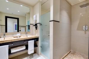 a bathroom with a shower and a sink at Royal Hideaway Sancti Petri in Chiclana de la Frontera