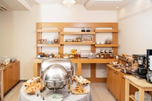 a kitchen with a table with a mixer on it at Olympus Terra Boutique Hotel in Larisa