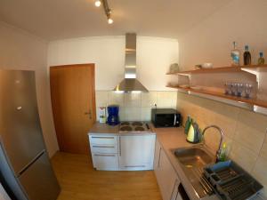 a small kitchen with a sink and a refrigerator at Apartment Ivan-Experience 3 Bedrooms in Ljubuški