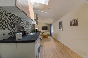 a kitchen with a counter top and a dining room at Villa Poncelet in Paris