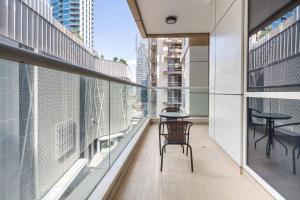 a balcony with two chairs and tables on a building at Frank Porter - Mon Reve in Dubai