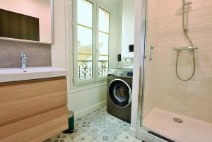 a bathroom with a washing machine next to a window at LE TOIT D'AUVERS - T2- 2e étage in Auvers-sur-Oise +17 photos