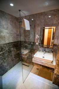 a bathroom with a sink and a shower at Exelans Hotel in Fethiye