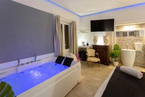 a living room with a large tub and a large window at Duomo Luxury Suite Catania in Catania