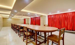 una gran sala de conferencias con una mesa larga y sillas en Treebo Trend Park, en Trivandrum