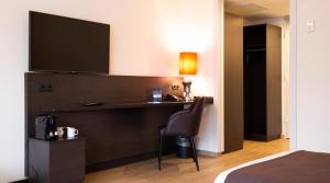 Postel nebo postele na pokoji v ubytování Bastion Hotel Apeldoorn Het Loo