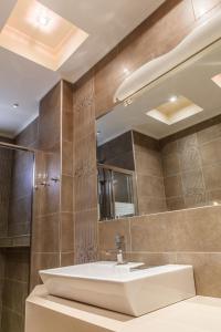a bathroom with a sink and a mirror at Villa Artemis Nafplion in Tolo