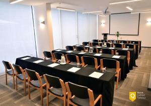 a row of tables and chairs in a room at Panamericana Hotel Providencia in Santiago +21 photos